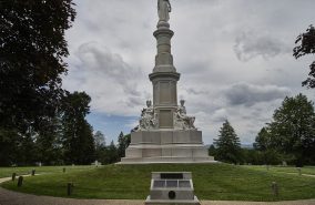 The 1869 Soldiers National Monument at Gettysburg National Cemetery (originally Soldiers National Cemetery) a United States national cemetery just outside Gettysburg, Pennsylvania, created for Union/Federal casualties of the July 1 to 3, 1863 Battle of Gettysburg in the American Civil War.  The United States 16th president, Abraham Lincoln, delivered his Gettysburg Address at the cemetery's consecration here four months after the battle.  The cemetery contains 3,512 interments from the Civil War, including the graves of 979 unknowns.